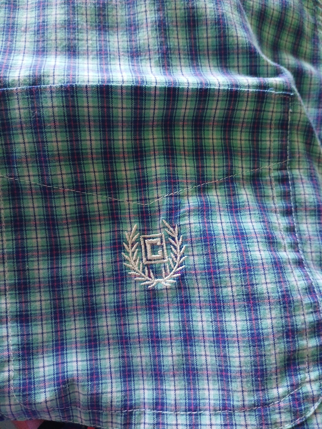 Plaid fabric with a logo in the center
