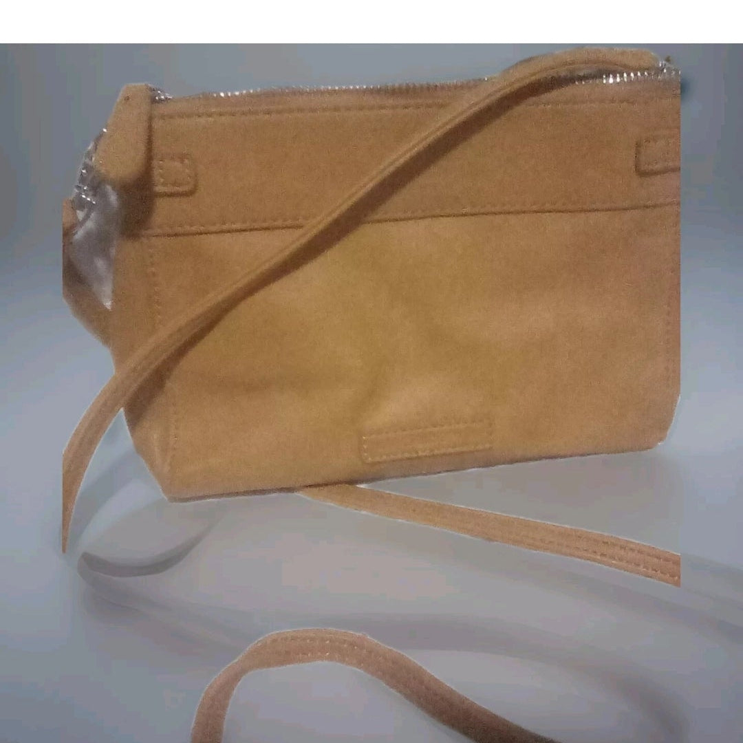 Tan handbag on a light gray background