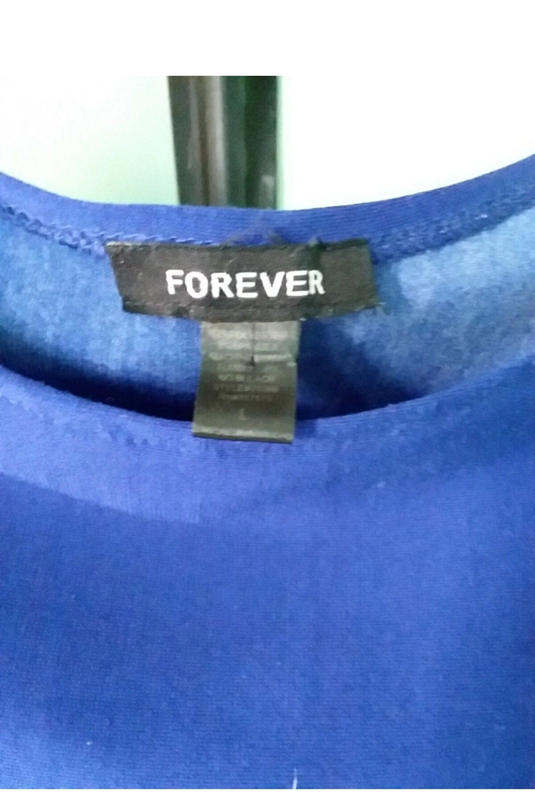 Blue fabric with a 'FOREVER' label on a blurred background