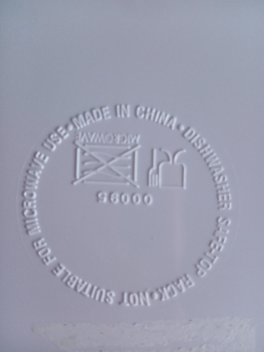 Embossed text and symbols on a gray background