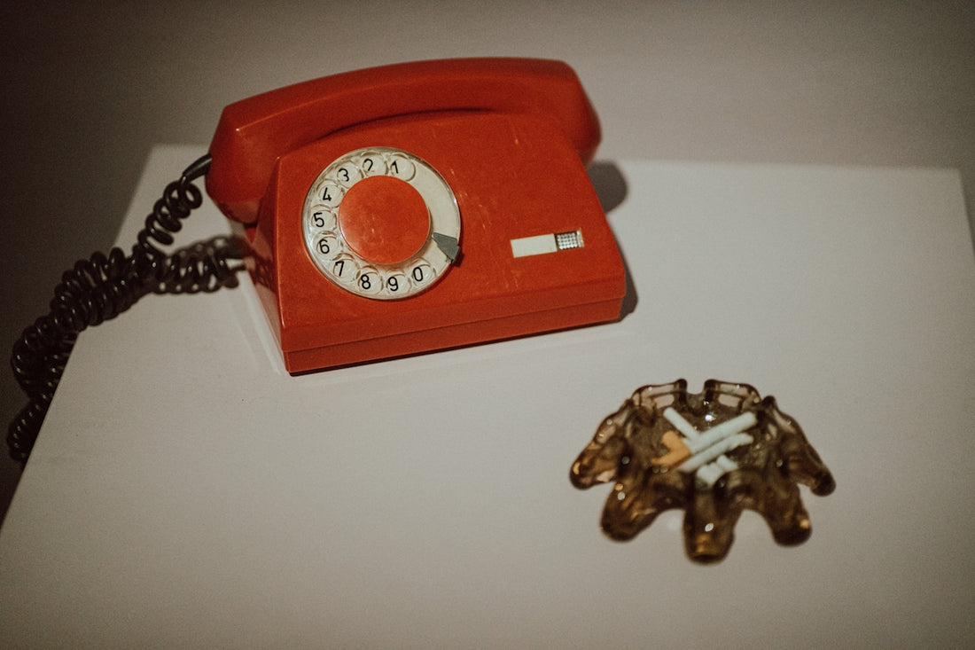 a red phone sitting on top of a white table