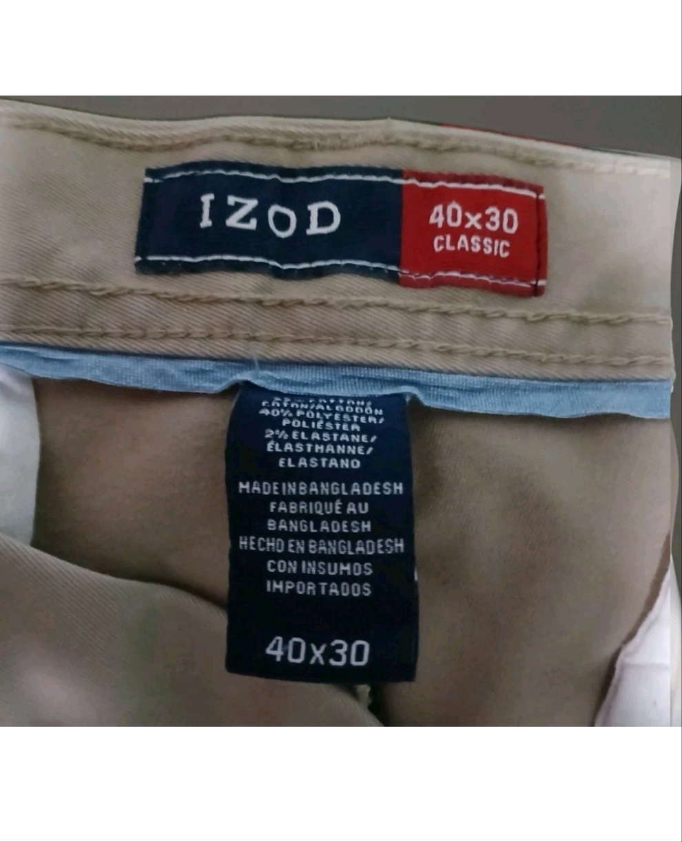Close-up of IZOD label on beige pants with size information.