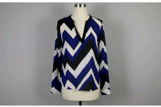 Blue and white chevron patterned blouse on a gray background