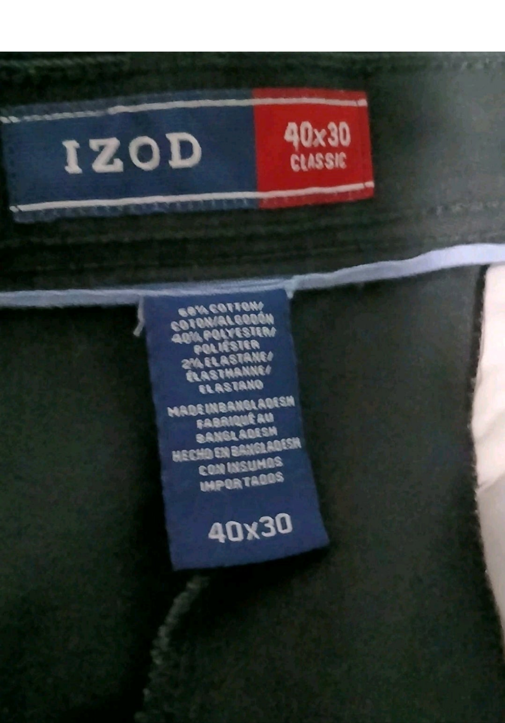 Close-up of IZOD label on a garment with material information.