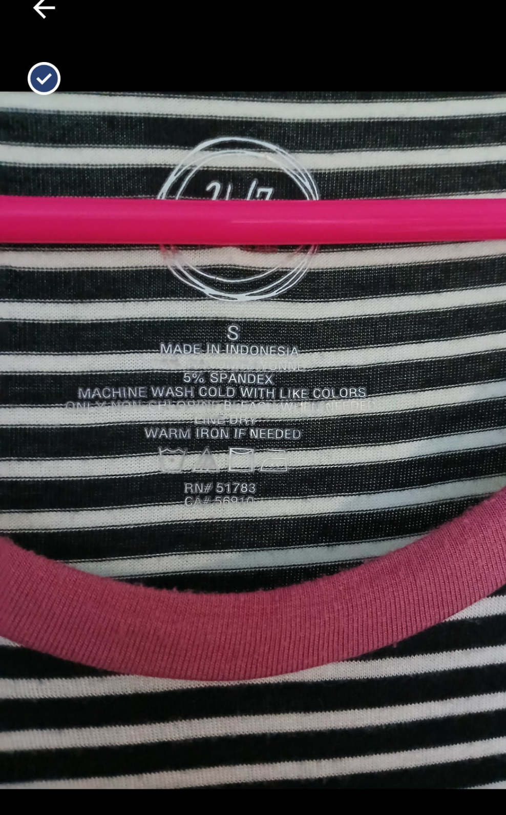 Close-up of a striped garment with a label on a black background