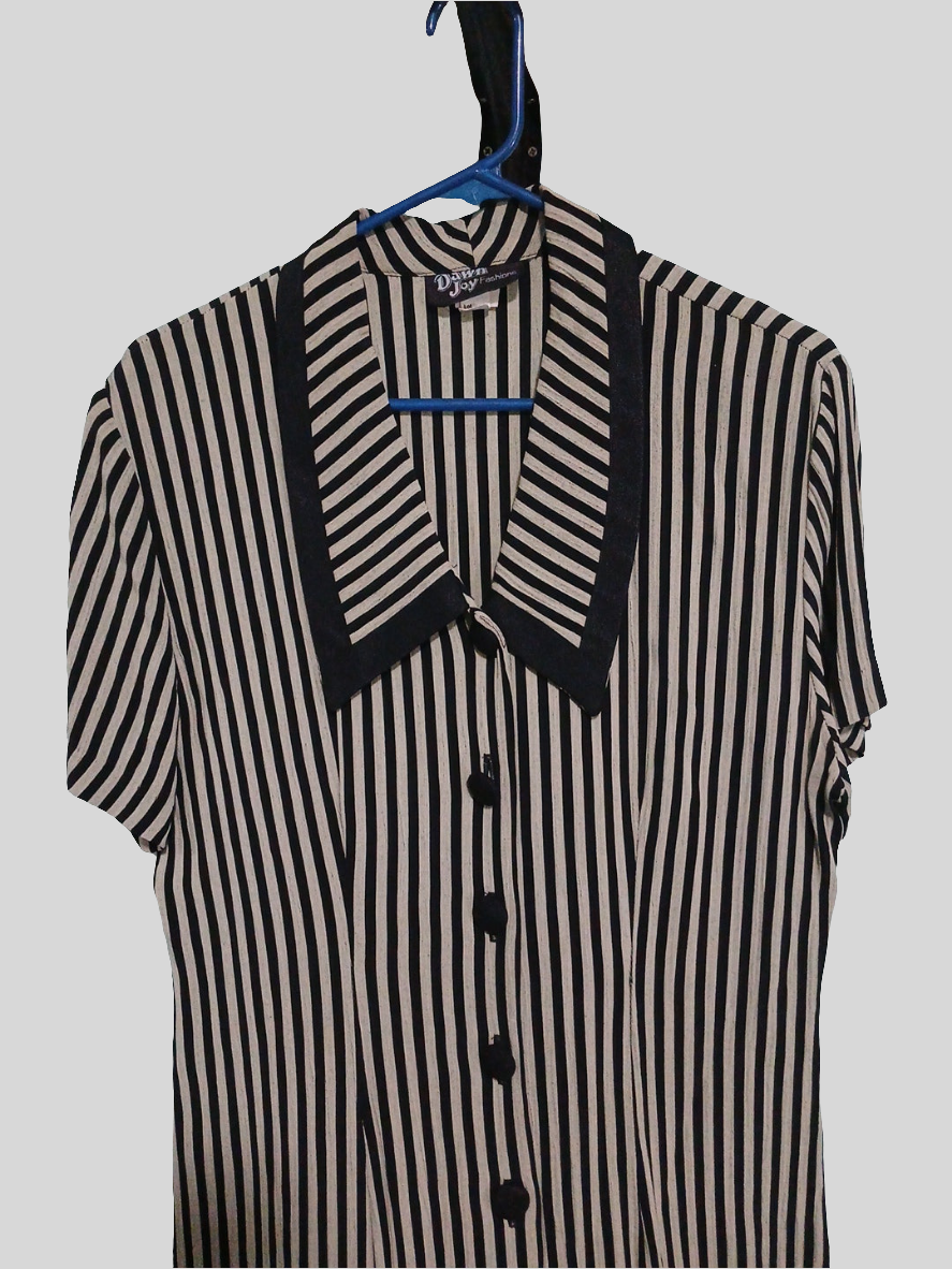 Black and white striped  dress on  a hanger against a gray background