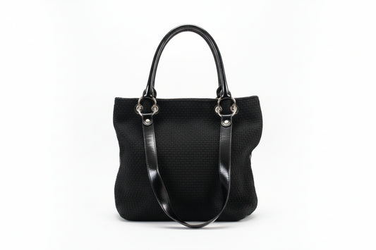 Black textured handbag with silver clasps on a white background