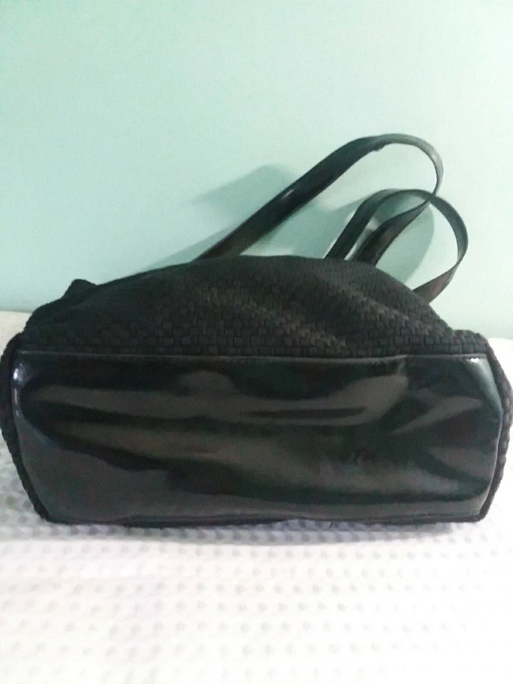 Black handbag on a light green background
