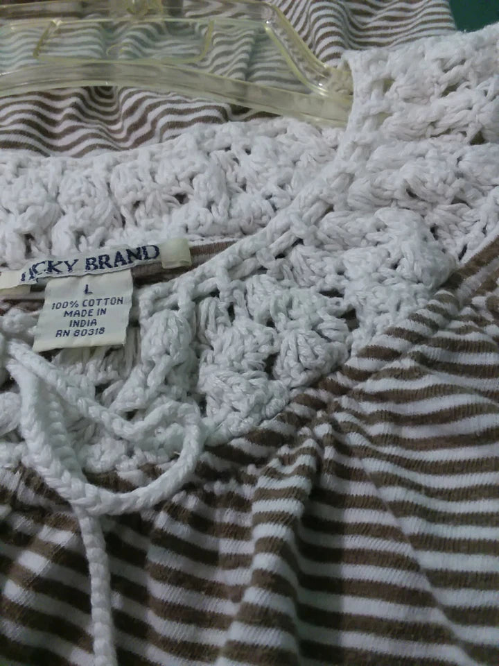 Striped fabric with a lucky Brand tag on a textured surface