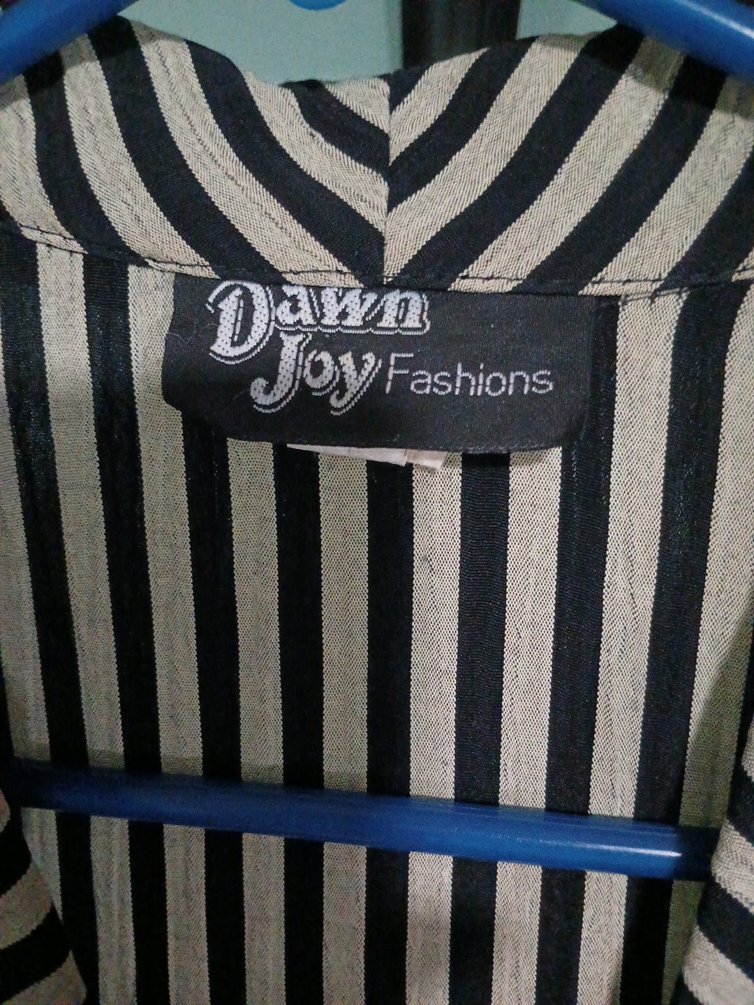 Striped fabric with a 'Dawn Joy Fashions' label on a blue background