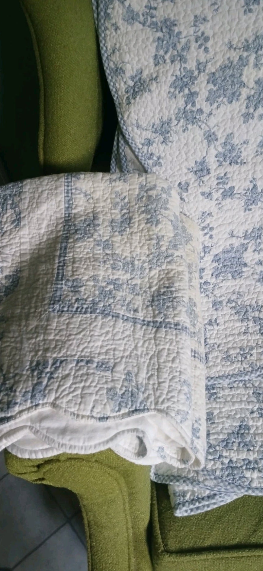Close-up of a textured blue and white fabric on a green surface