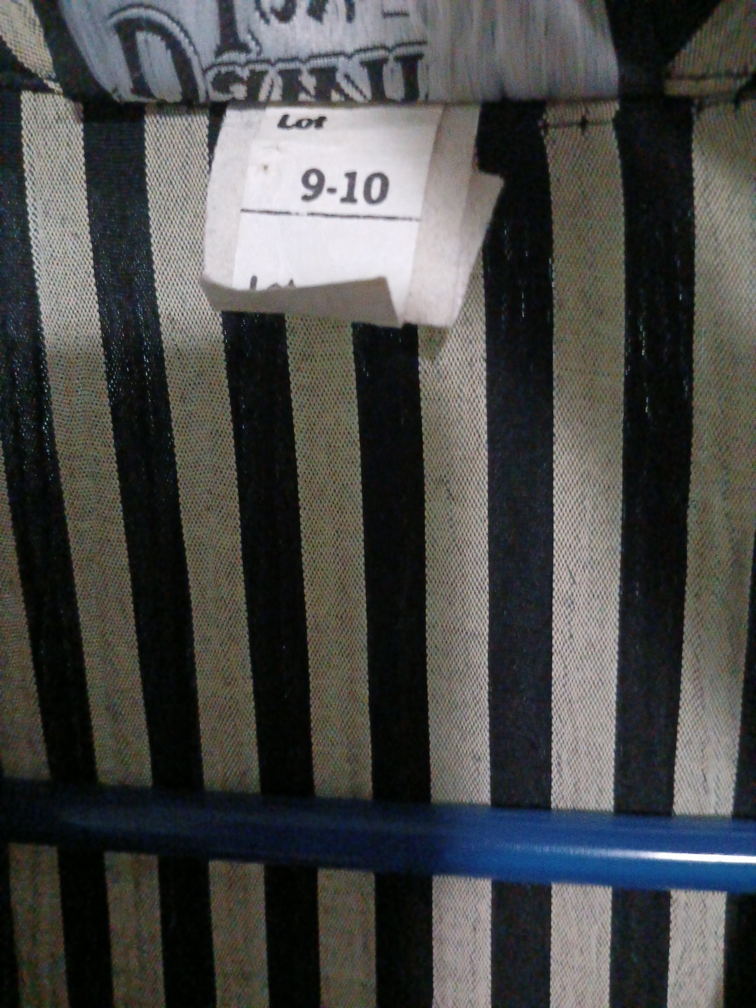Black and white striped fabric with  a clothing tag on a striped background