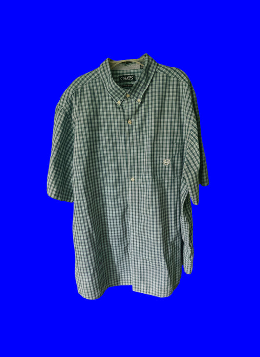Green and white checkered shirt on a hanger against a blue background