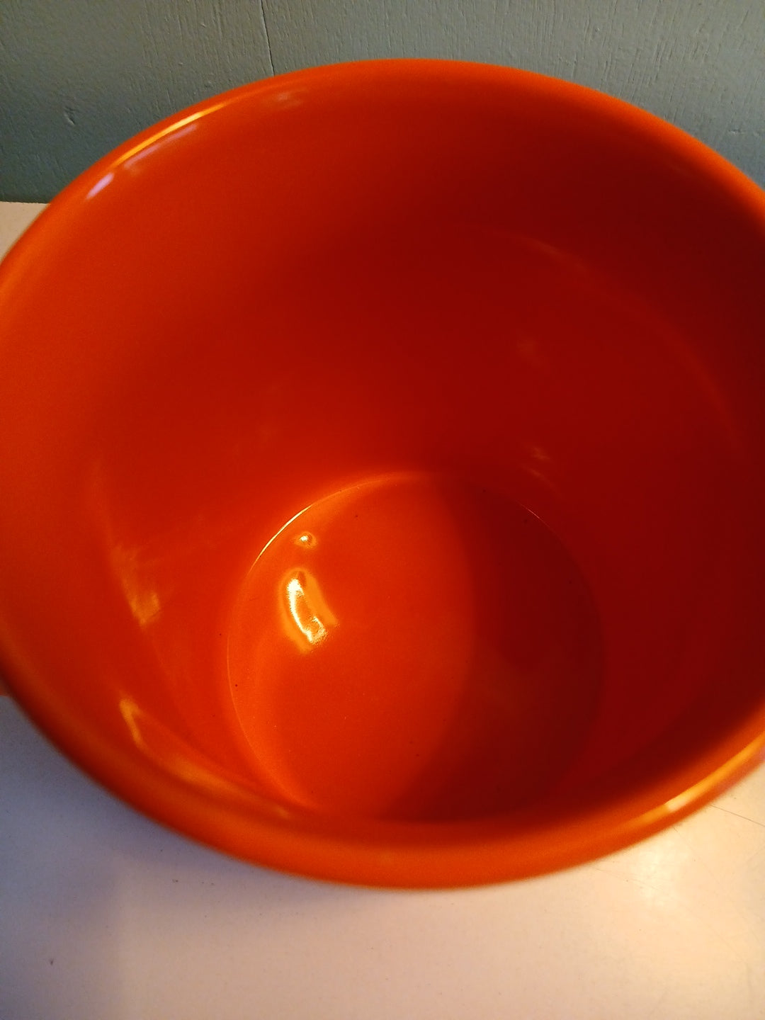Close-up of an orange bowl on a neutral background