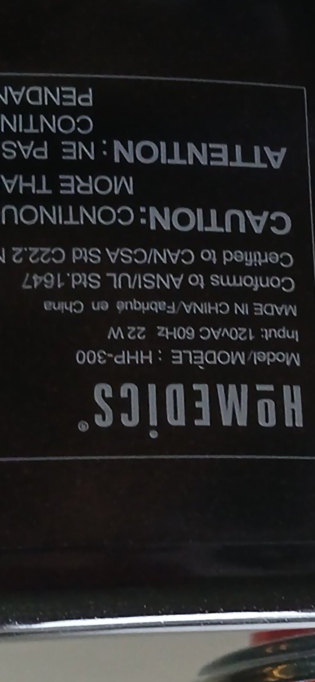 Close-up of a label with text and branding on a black background