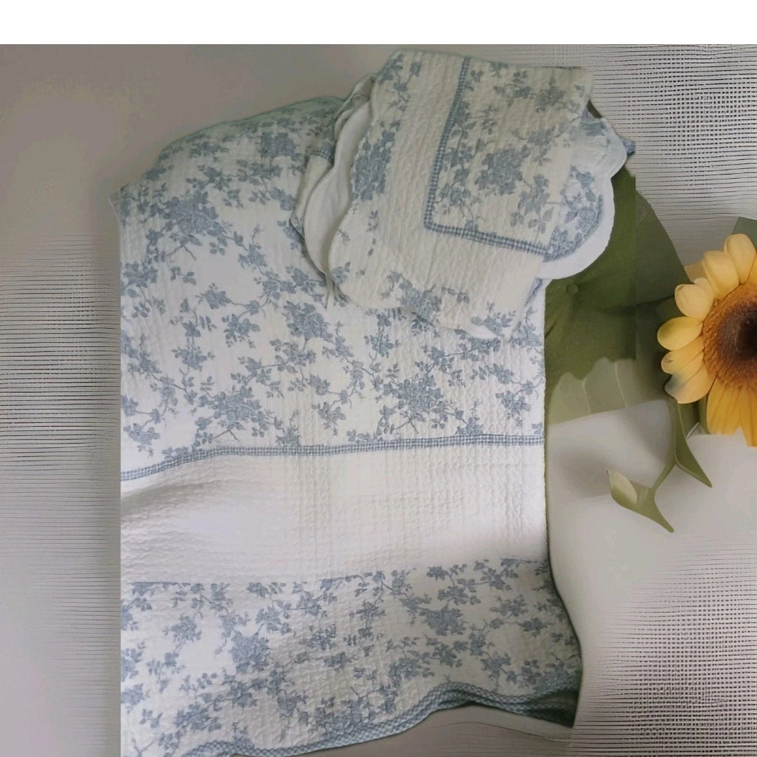 Floral-patterned tablecloth on a table with a sunflower