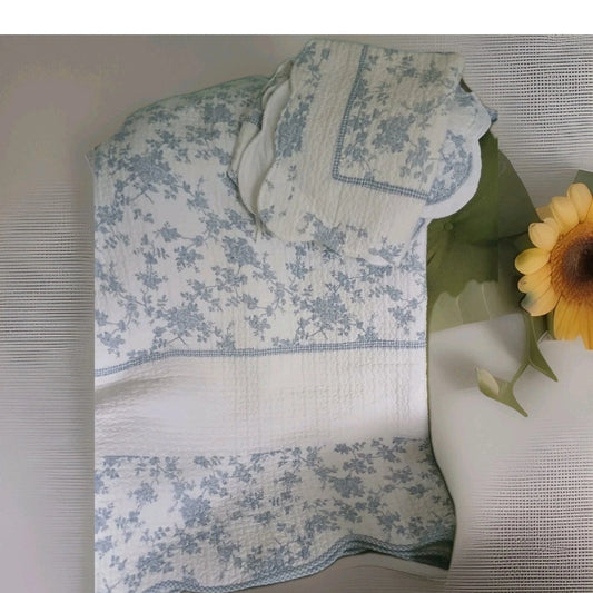 Floral-patterned tablecloth on a table with a sunflower