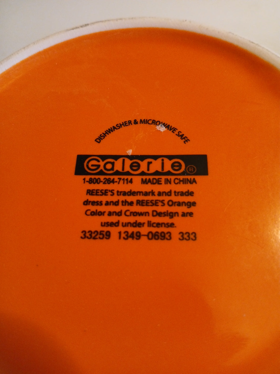  bottom of Orange cup with galerie branding and text on a white background