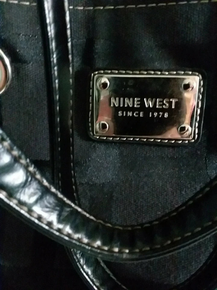 Close-up of a Nine West handbag with a metallic logo tag.