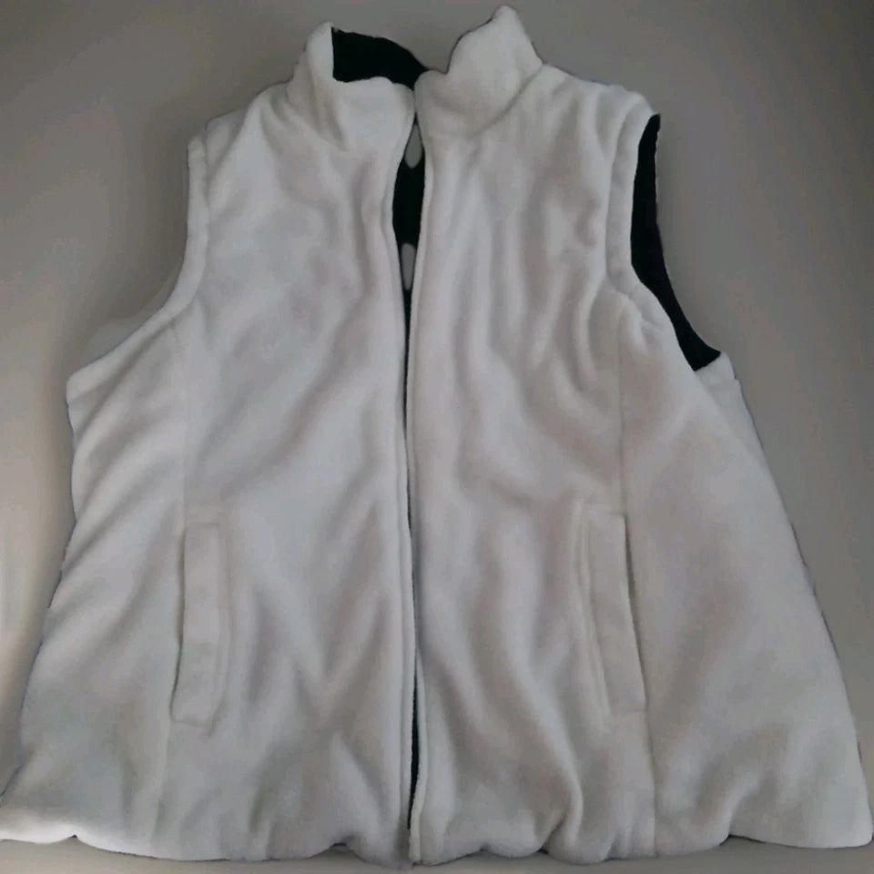 White fleece vest with black interior lining on a gray background