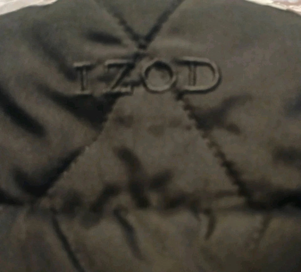 Close-up of a textured black surface with 'Izod' branding.